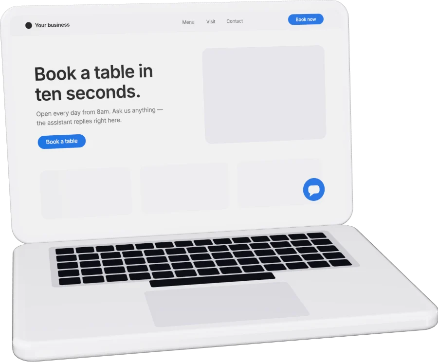 An open laptop showing a business website with a chat button.